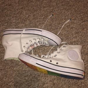High top Converse rainbow bottoms.